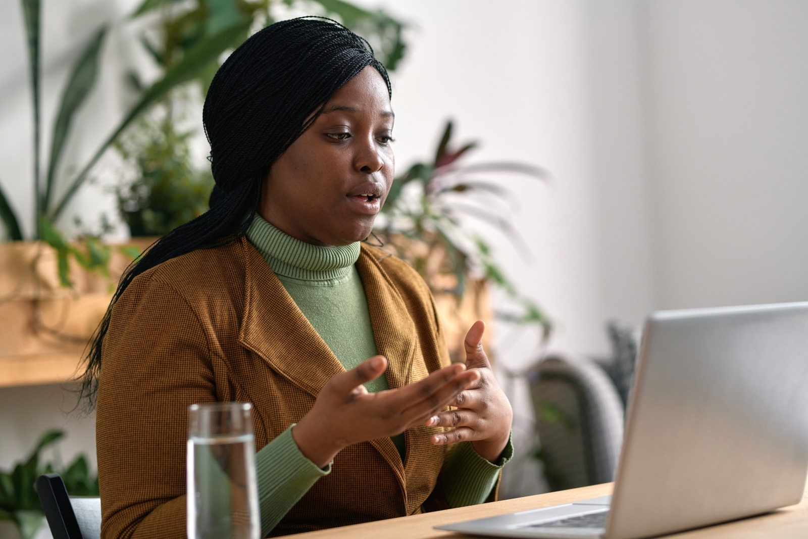 Woman with laptop participating in online meeting