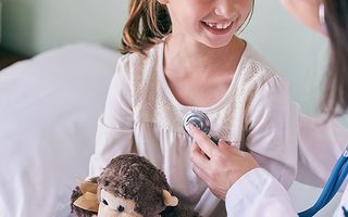 doctor with stethoscope and a child