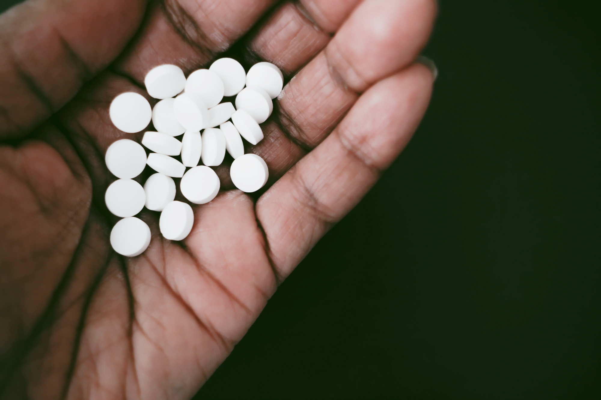 White pills in open hand