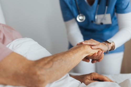 Clinician holding patient’s hand