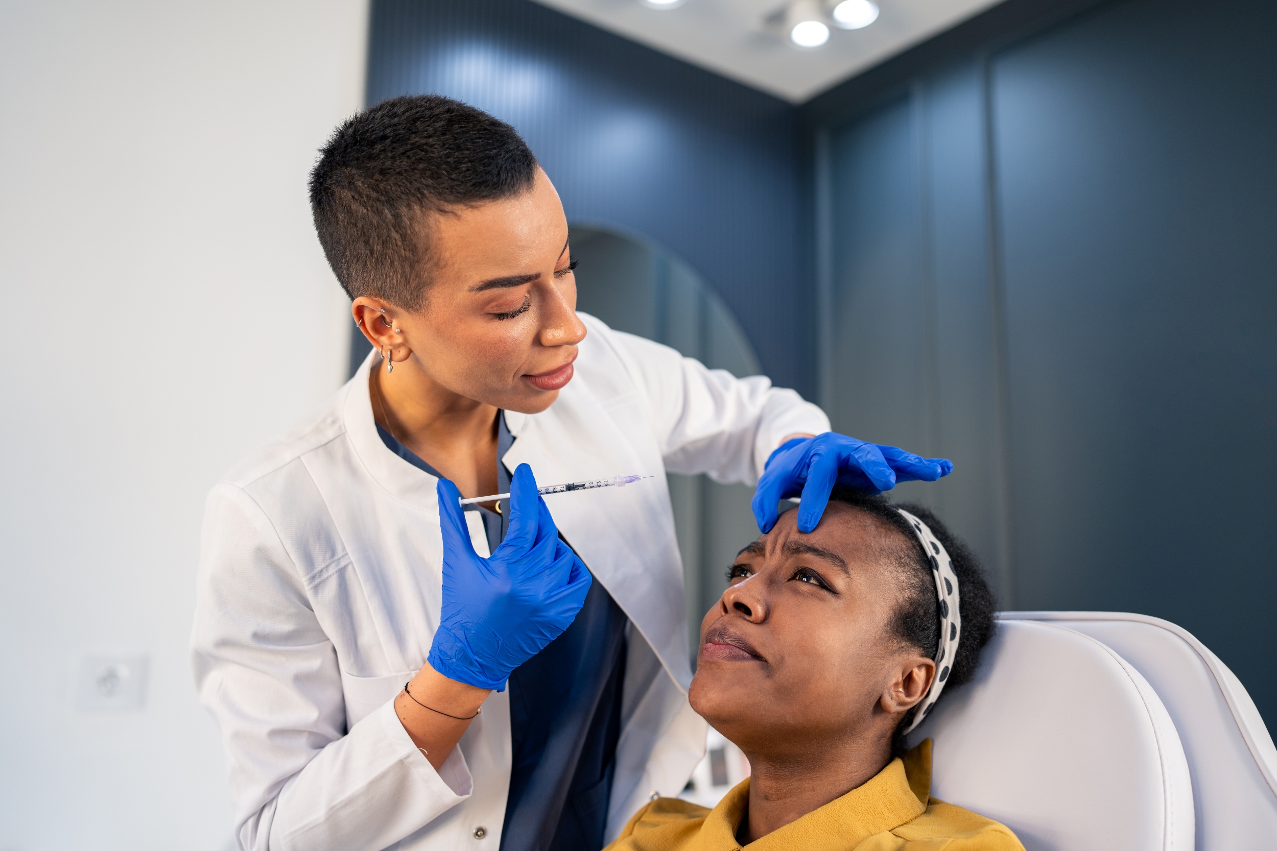 Physician giving patient an injection in the face