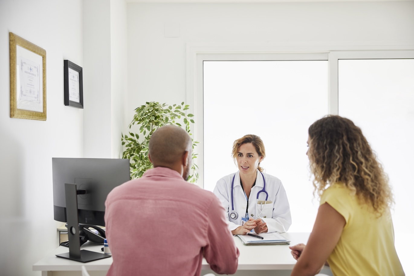 couple meeting with a provider to discuss having a baby.