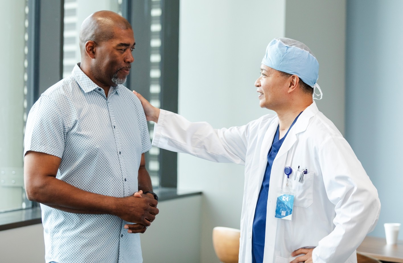 Male patient consulting with male surgeon