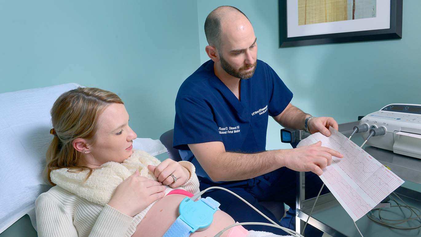 Dr. Robert Stewart discussing the fetal heart rate with an expecting mother.