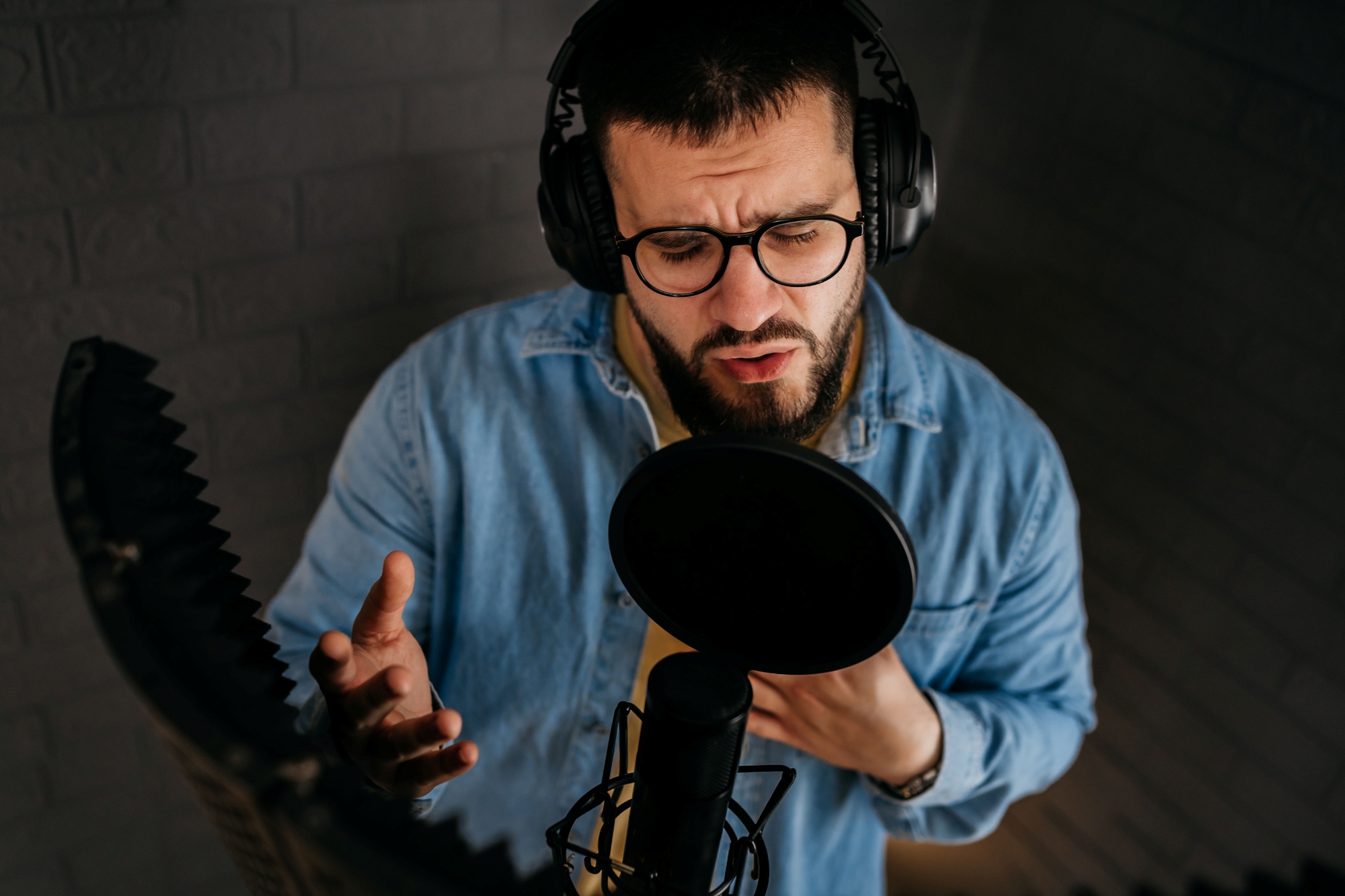 male singer recording in a studio