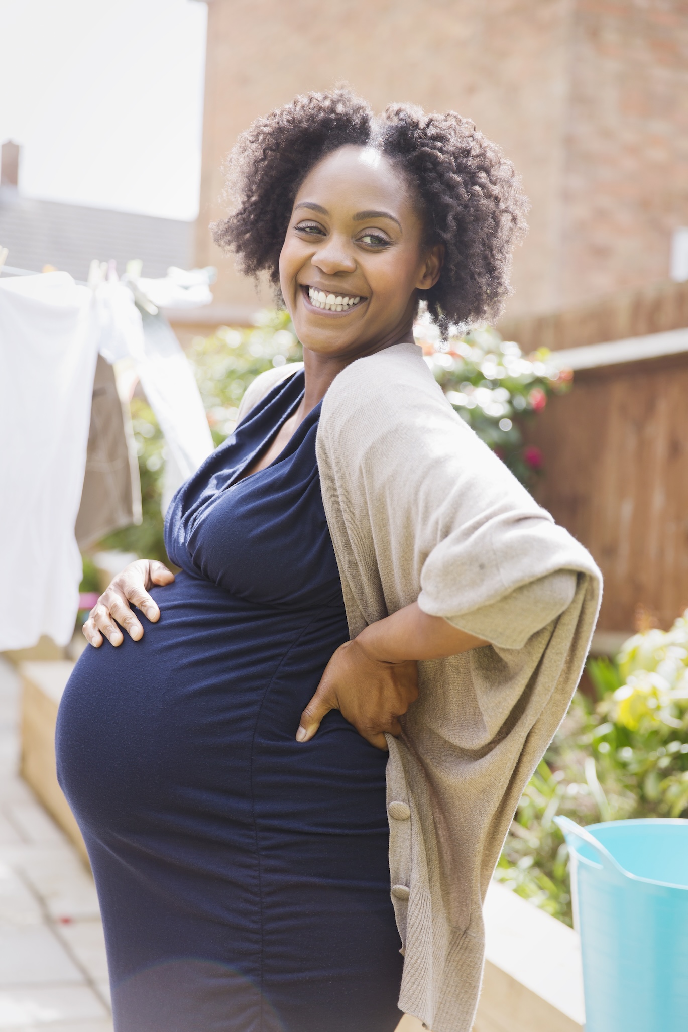 smiling pregnant woman looking directly at the camera