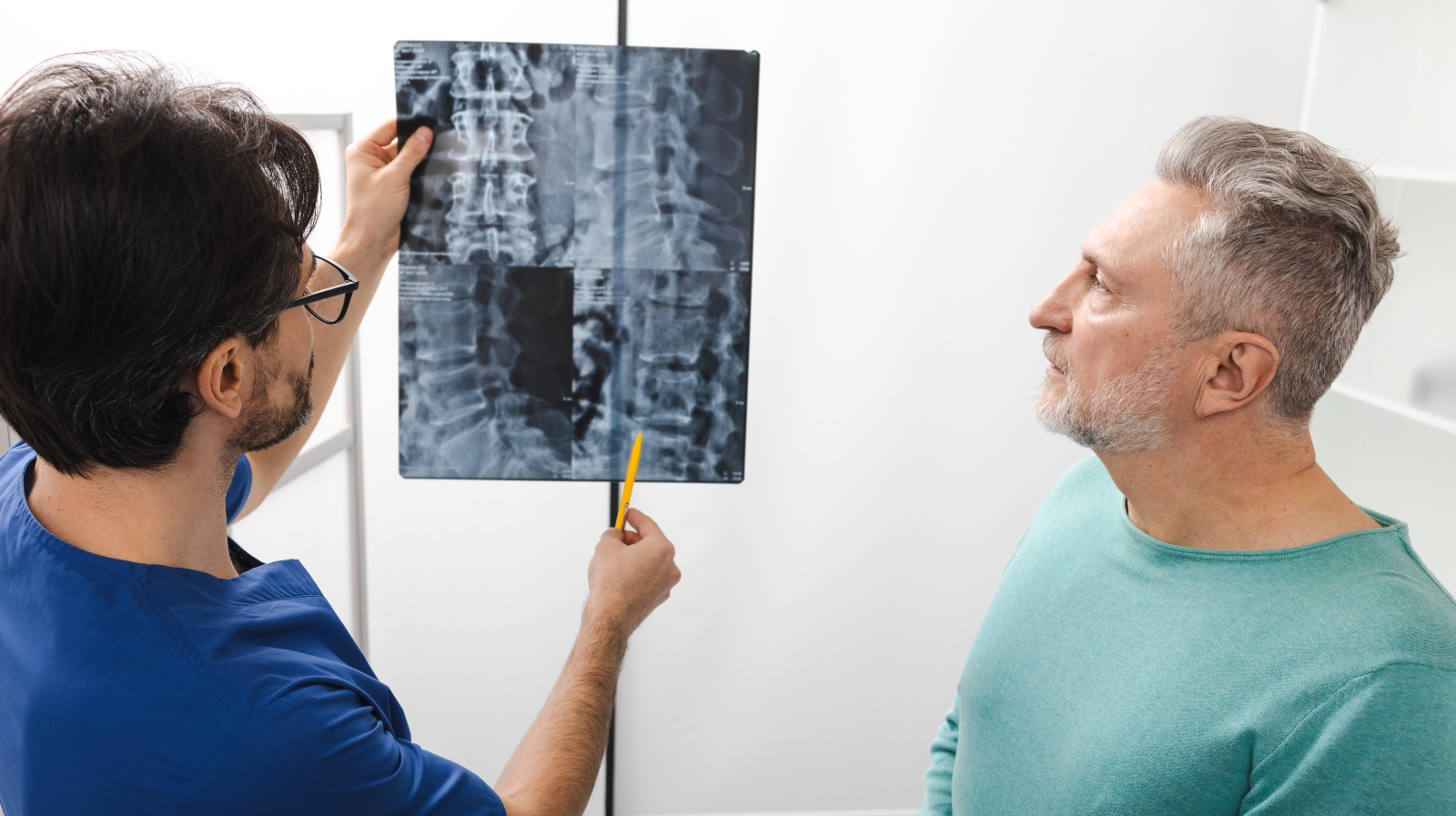 doctor reviewing spine X-ray with patient