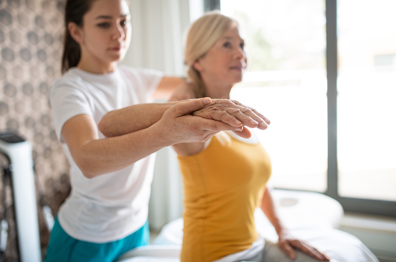 Physiotherapist working with senior patient