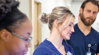 three nurses talking