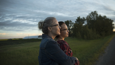 two women standing outdoors at dusk