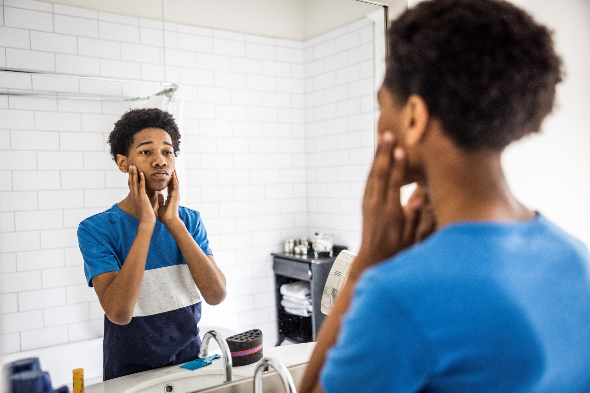 Teen boy looking in mirror
