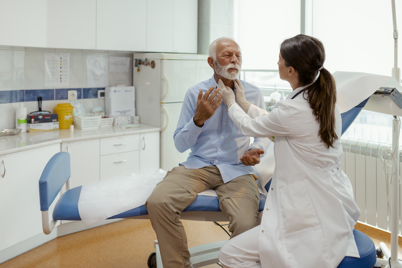 Throat Swelling Check by Caring Female Doctor During Senior Exam
