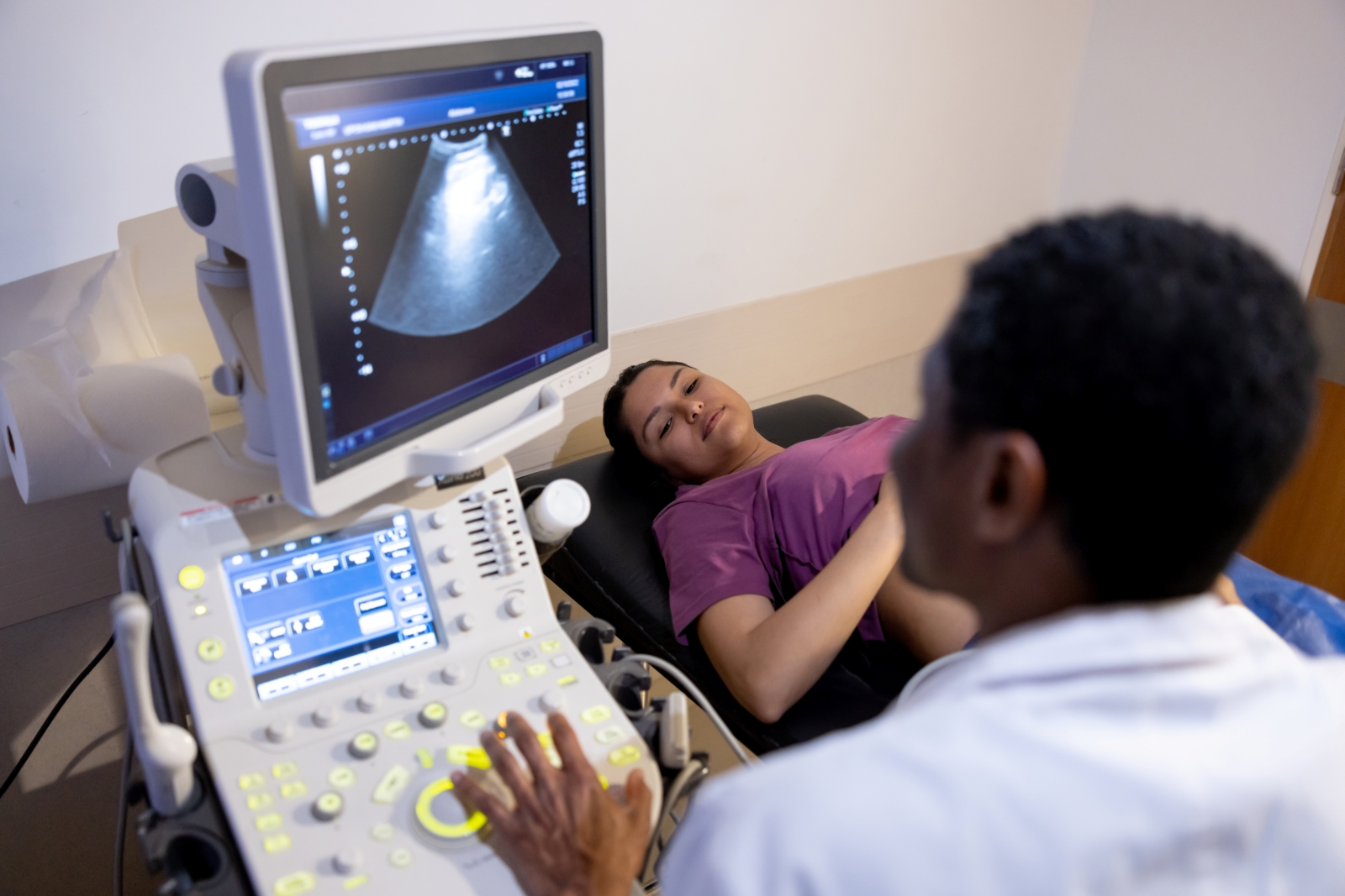 Pregnant woman is getting an ultrasound from a medical person