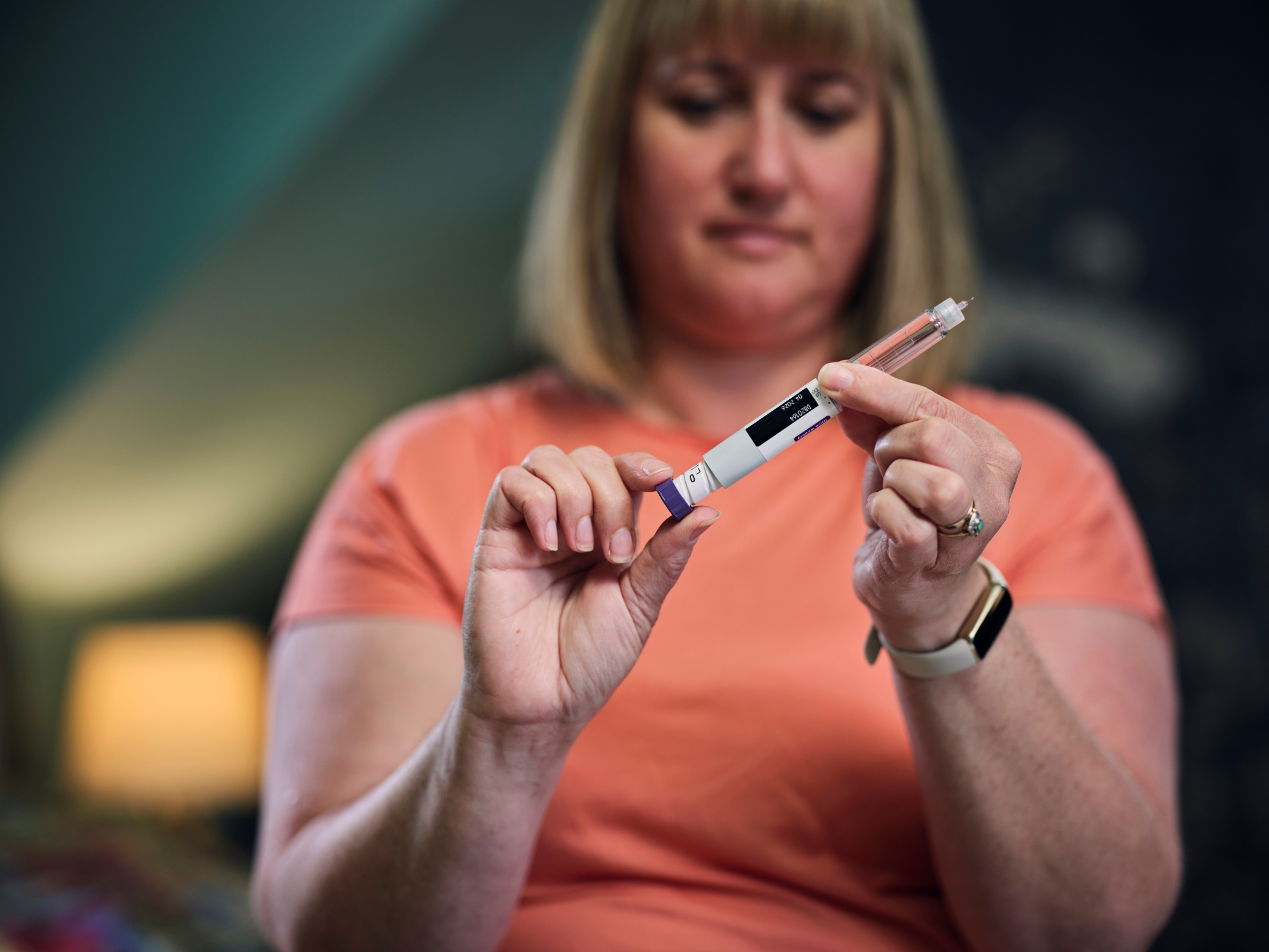 woman holding injection tool for weight loss drug