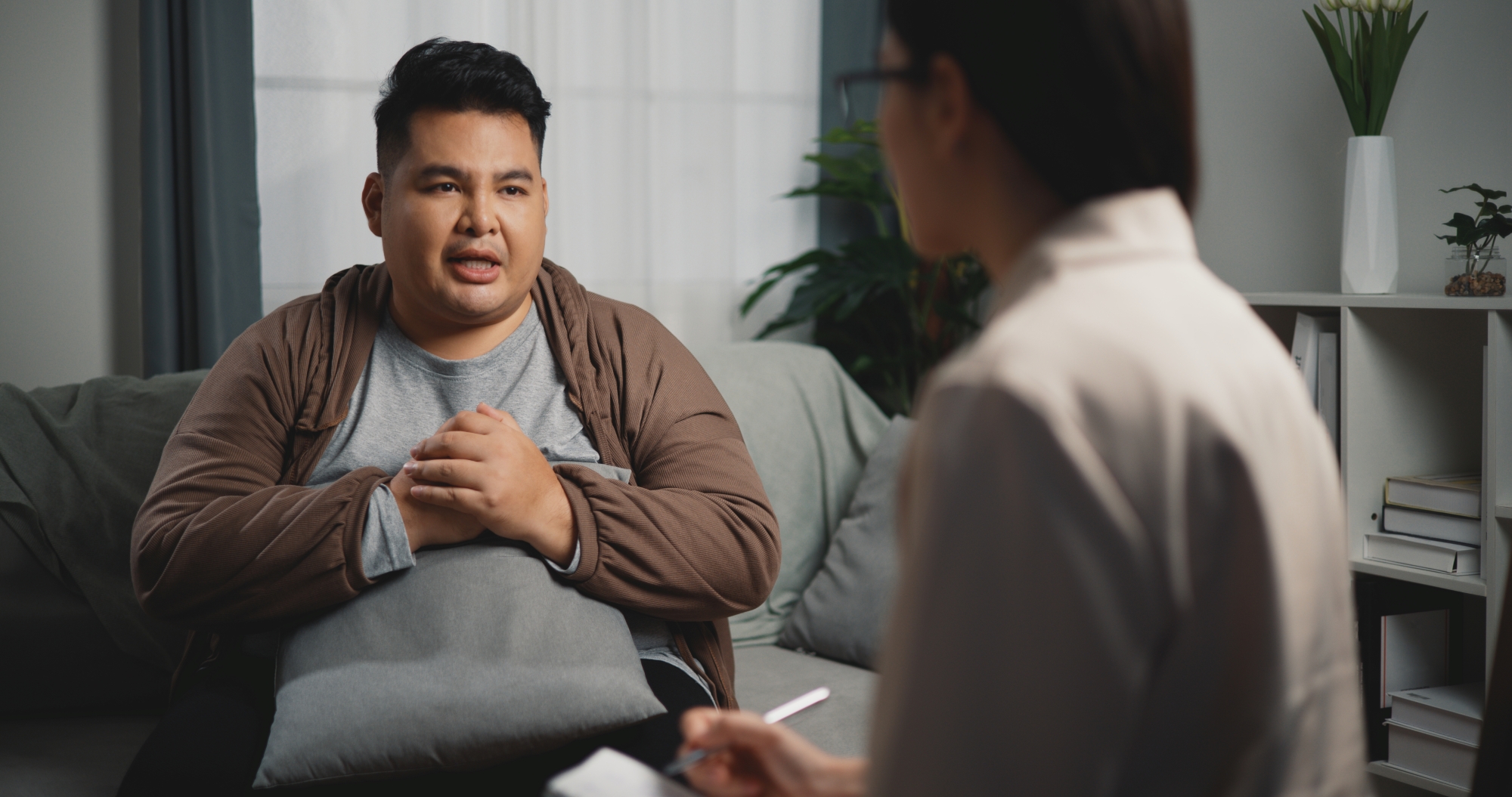 Man with obesity talking with a therapist