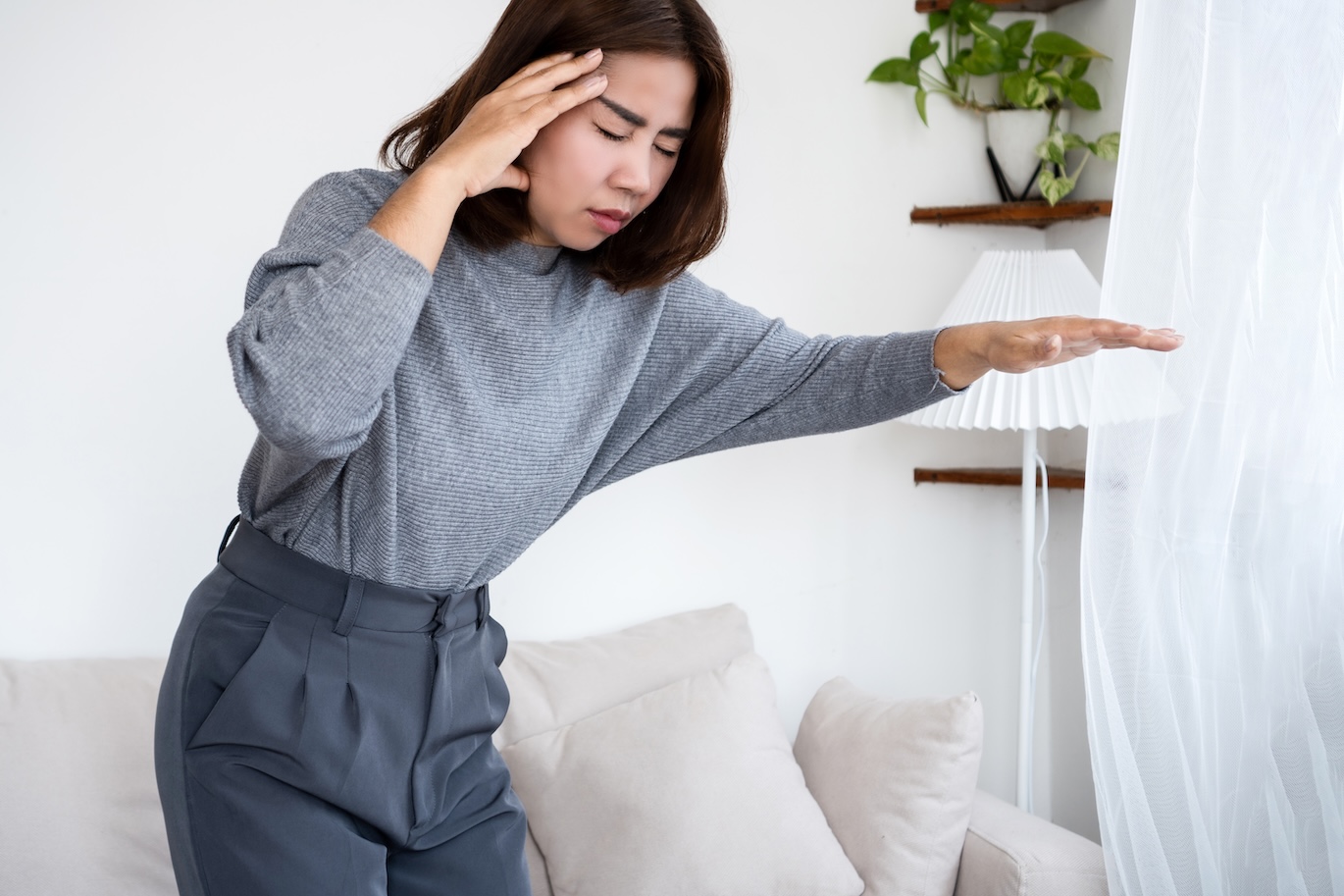 Asian woman feel dizziness and lightheadedness upon standing
