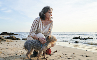 woman on beach with dog