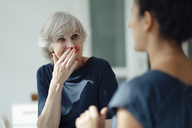 Surprised woman speaking with another woman