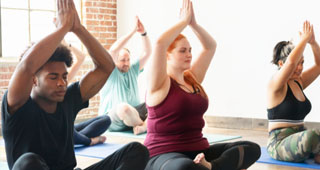 three people in a yoga pose