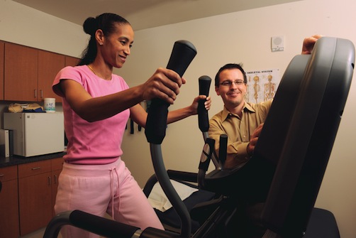Jason Zafereo, M.P.T., works with a patient in physical therapy to increase range of motion, muscle strength, endurance, coordination, and overall conditioning.